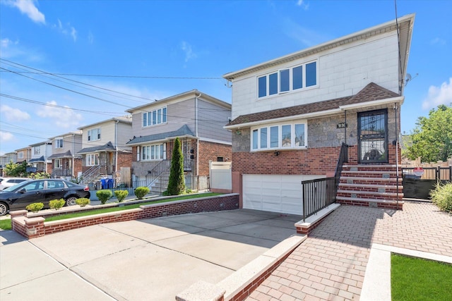 1159 129th St, College Point, NY 11356 - view of front facade with an attached garage, driveway, and a residential view
