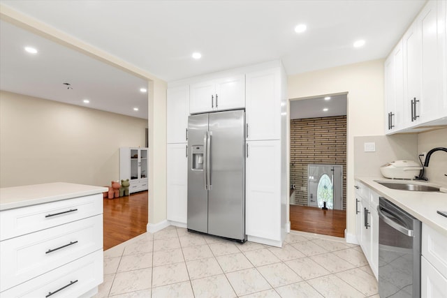 27 Heron Ln, Commack, NY 11725 - kitchen featuring appliances with stainless steel finishes, light countertops, white cabinets, and recessed lighting