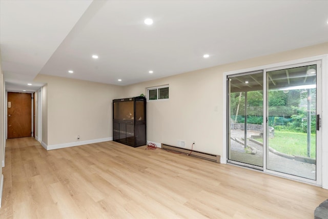 27 Heron Ln, Commack, NY 11725 - spare room with a baseboard heating unit, light wood-type flooring, and recessed lighting