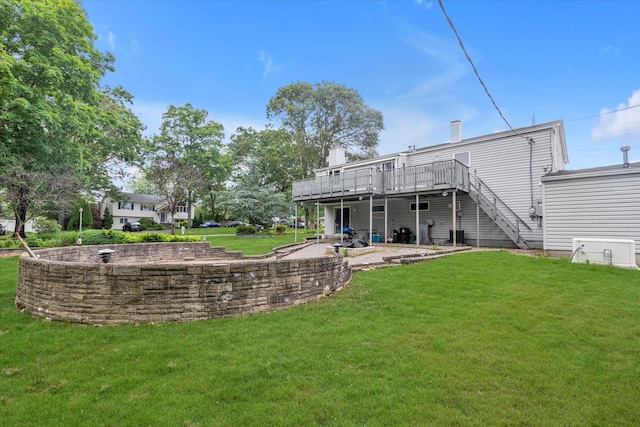 27 Heron Ln, Commack, NY 11725 - rear view of house with a wooden deck, a yard, stairs, and a chimney