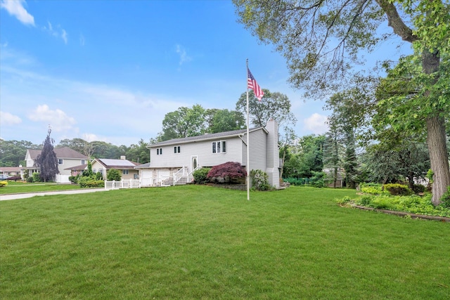 27 Heron Ln, Commack, NY 11725 - view of front of property featuring a chimney and a front lawn