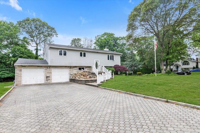 27 Heron Ln, Commack, NY 11725 - raised ranch with decorative driveway, a chimney, a front lawn, and stone siding