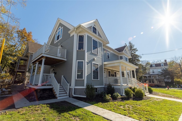 22 Forbus St, Poughkeepsie, NY 12601 - view of home's exterior with covered porch, a balcony, and a lawn
