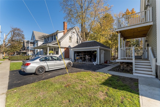 22 Forbus St, Poughkeepsie, NY 12601 - view of side of home featuring an outbuilding, a garage, a balcony, and a yard