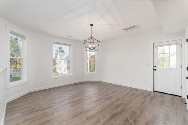 22 Forbus St, Poughkeepsie, NY 12601 - unfurnished dining area with a chandelier and wood finished floors
