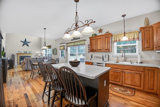 85 Decker Dr, Walden, NY 12586 - kitchen with light wood-style floors, light countertops, open floor plan, brown cabinetry, and healthy amount of natural light