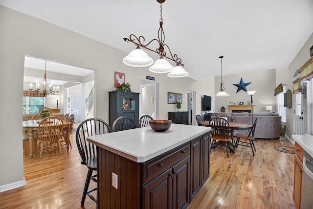 85 Decker Dr, Walden, NY 12586 - kitchen with a kitchen breakfast bar, light countertops, a chandelier, light wood-style floors, and open floor plan