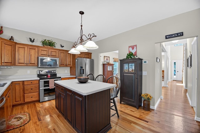 85 Decker Dr, Walden, NY 12586 - kitchen featuring stainless steel appliances, a kitchen breakfast bar, light countertops, and light wood-type flooring