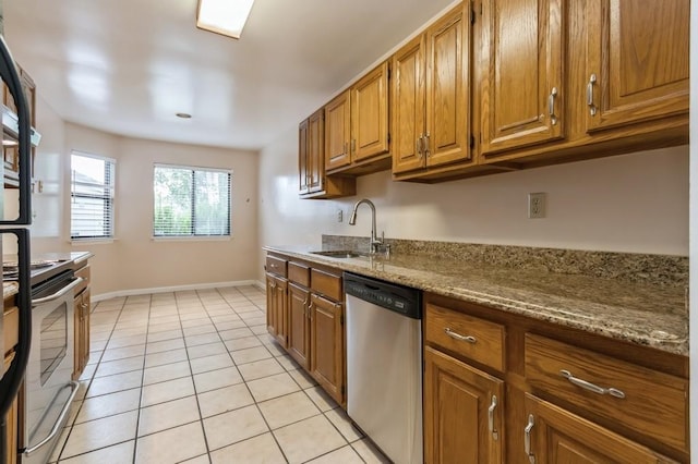 175 Horseshoe Cir, Ossining, NY 10562 - kitchen featuring stainless steel dishwasher, range with electric stovetop, brown cabinets, and light tile patterned flooring
