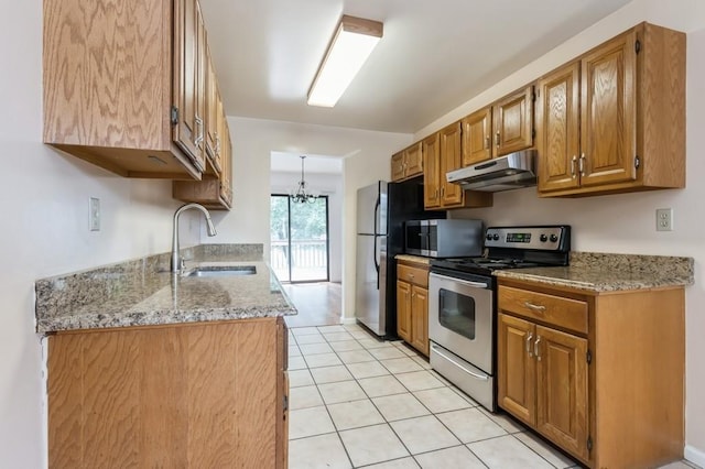 175 Horseshoe Cir, Ossining, NY 10562 - kitchen with appliances with stainless steel finishes, under cabinet range hood, light tile patterned flooring, brown cabinets, and light stone countertops