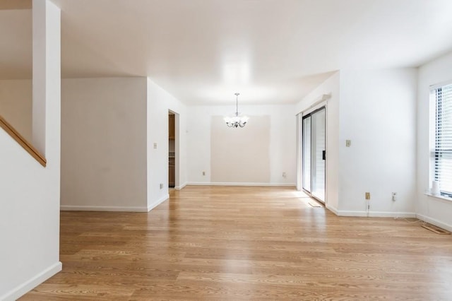175 Horseshoe Cir, Ossining, NY 10562 - empty room with a chandelier and light wood finished floors