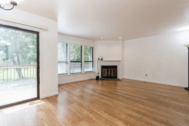 175 Horseshoe Cir, Ossining, NY 10562 - unfurnished living room with a fireplace with flush hearth, light wood finished floors, and recessed lighting