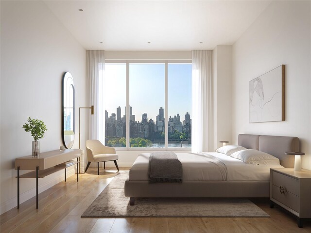 30-55 Vernon Blvd Unit 5N, Long Island City, NY 11102 - bedroom featuring wood finished floors, multiple windows, and a skyline view