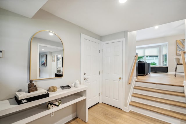 9 Elaine Pl, Plainview, NY 11803 - foyer entrance featuring light wood finished floors, recessed lighting, arched walkways, and stairs