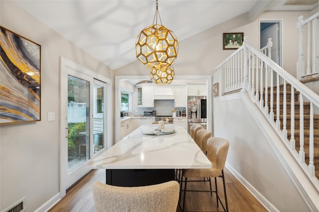 9 Elaine Pl, Plainview, NY 11803 - dining area with wood finished floors, stairs, and vaulted ceiling