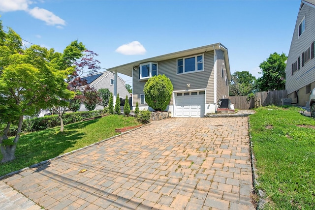 7 Fuller Rd, Ossining, NY 10562 - view of front facade featuring decorative driveway and a garage