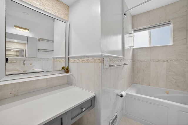 7 Fuller Rd, Ossining, NY 10562 - full bath featuring tile walls, vanity,  shower combination, and a wainscoted wall