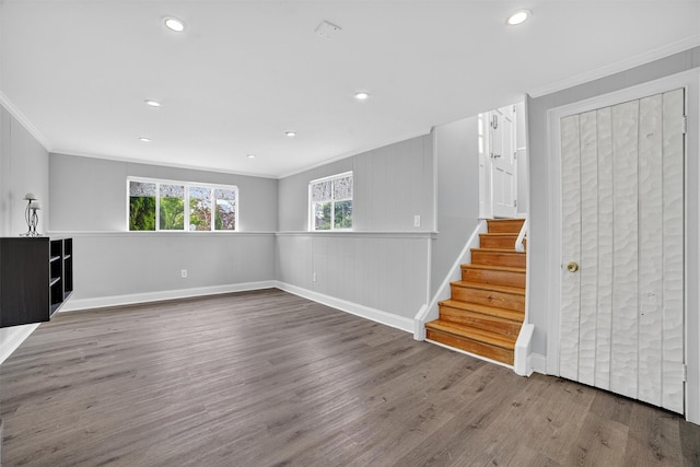 7 Fuller Rd, Ossining, NY 10562 - unfurnished living room with crown molding, plenty of natural light, wood finished floors, stairs, and recessed lighting