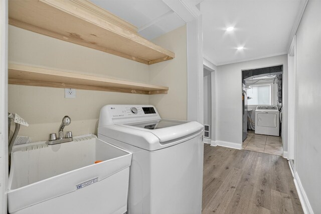 7 Fuller Rd, Ossining, NY 10562 - washroom featuring washer / dryer, light wood-style flooring, and ornamental molding