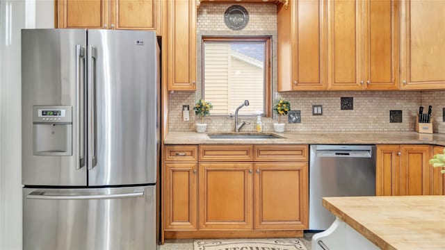 17111 Bagley Ave, Flushing, NY 11358 - kitchen featuring appliances with stainless steel finishes, tasteful backsplash, light stone counters, and brown cabinetry