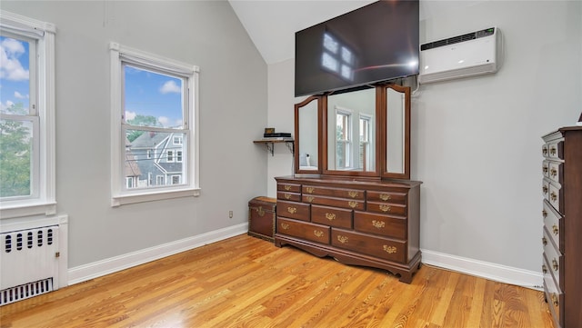 17111 Bagley Ave, Flushing, NY 11358 - bedroom with radiator heating unit, a wall mounted AC, light wood finished floors, multiple windows, and vaulted ceiling