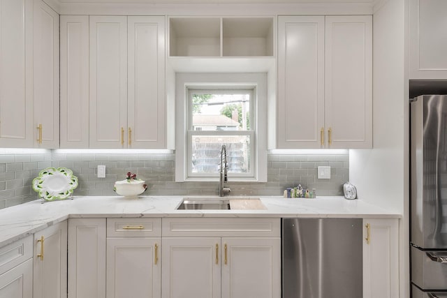 2040 Wellington Ct, Westbury, NY 11590 - kitchen featuring freestanding refrigerator, white cabinets, stainless steel fridge, and backsplash