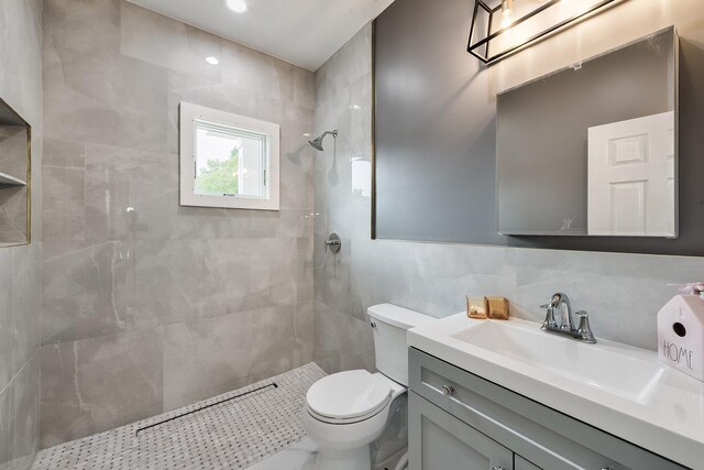 2040 Wellington Ct, Westbury, NY 11590 - bathroom featuring tiled shower, vanity, and tile walls