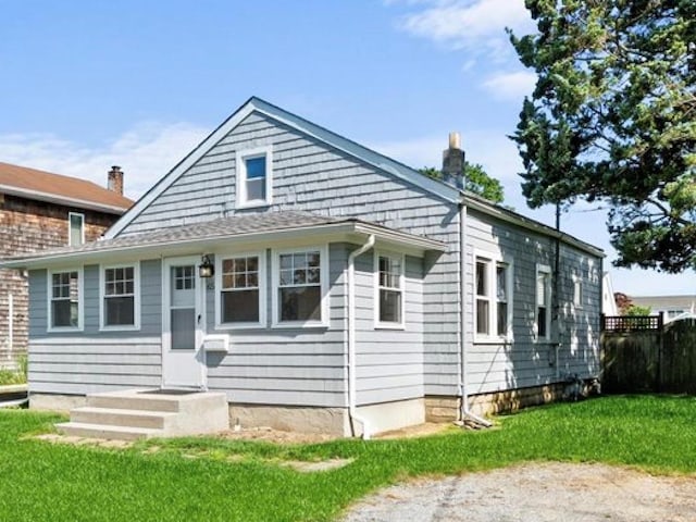 65 Schmeelk Pl, Copiague, NY 11726 - view of front of house with a chimney and a front yard