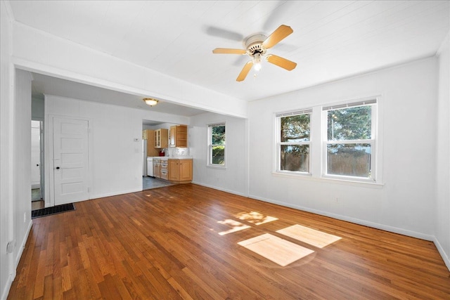 65 Schmeelk Pl, Copiague, NY 11726 - unfurnished living room with dark wood-style flooring, plenty of natural light, and ceiling fan