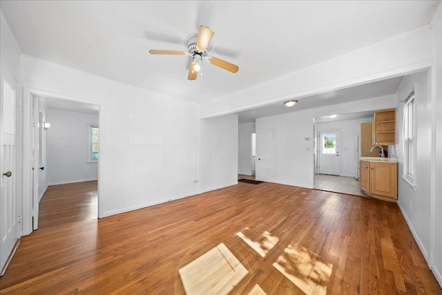 65 Schmeelk Pl, Copiague, NY 11726 - unfurnished living room with a ceiling fan, light wood-style floors, and plenty of natural light