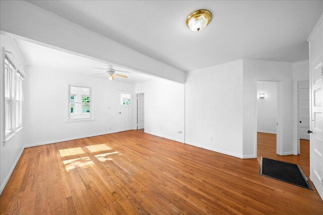 65 Schmeelk Pl, Copiague, NY 11726 - unfurnished living room with light wood-type flooring and ceiling fan