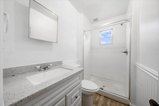 65 Schmeelk Pl, Copiague, NY 11726 - bathroom with a shower stall, vanity, wood finished floors, and wainscoting