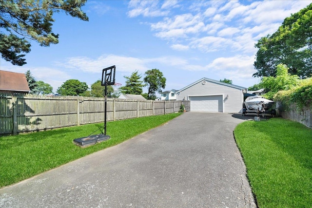 65 Schmeelk Pl, Copiague, NY 11726 - view of yard with a garage and asphalt driveway