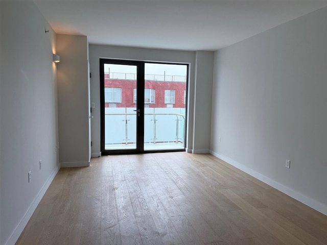 136-80 41st Ave Unit 6G, Flushing, NY 11355 - unfurnished room with wood finished floors and french doors
