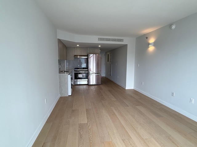 136-80 41st Ave Unit 6G, Flushing, NY 11355 - unfurnished living room with a sink and light wood-type flooring