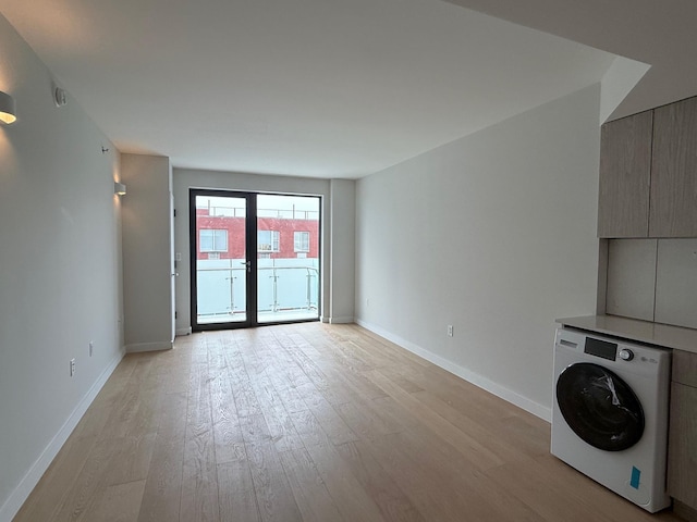 136-80 41st Ave Unit 6G, Flushing, NY 11355 - unfurnished living room featuring washer / dryer and light wood-style flooring