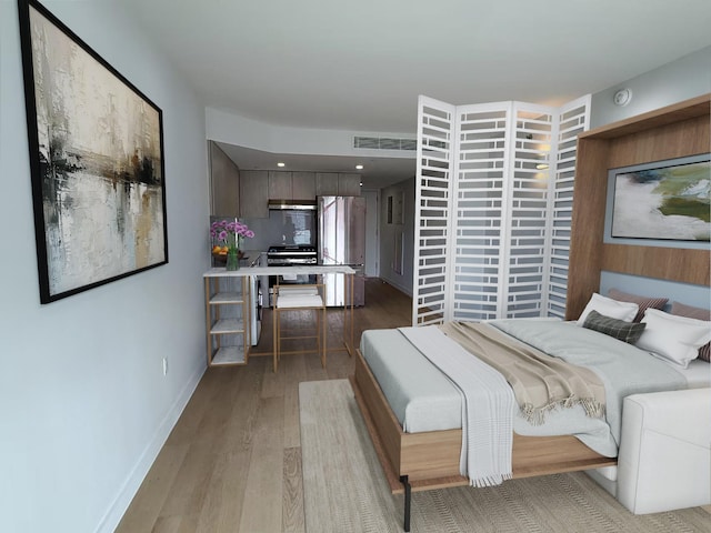 136-80 41st Ave Unit 6G, Flushing, NY 11355 - bedroom with freestanding refrigerator and light wood-style floors