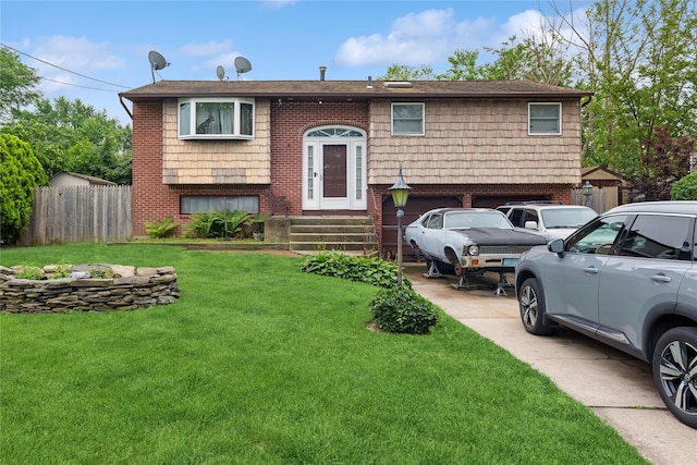 18 Berkeley Ave, Selden, NY 11784 - split foyer home with an attached garage, concrete driveway, and brick siding