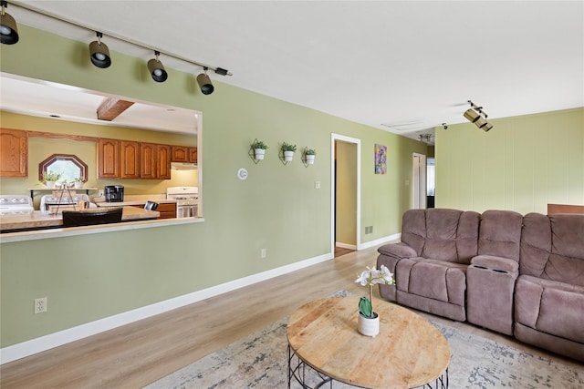 18 Berkeley Ave, Selden, NY 11784 - living area featuring light wood finished floors and rail lighting
