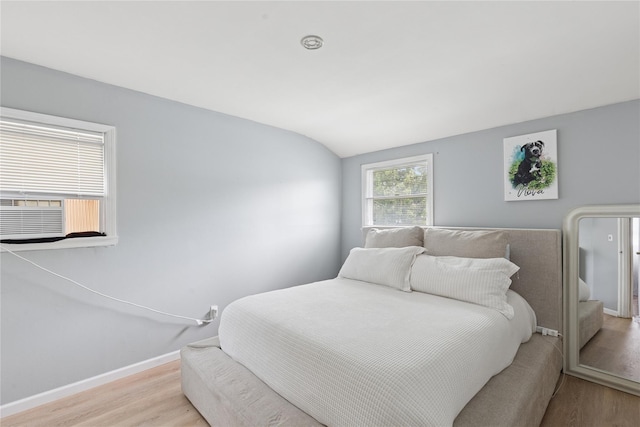 18 Berkeley Ave, Selden, NY 11784 - bedroom featuring wood finished floors, cooling unit, and lofted ceiling