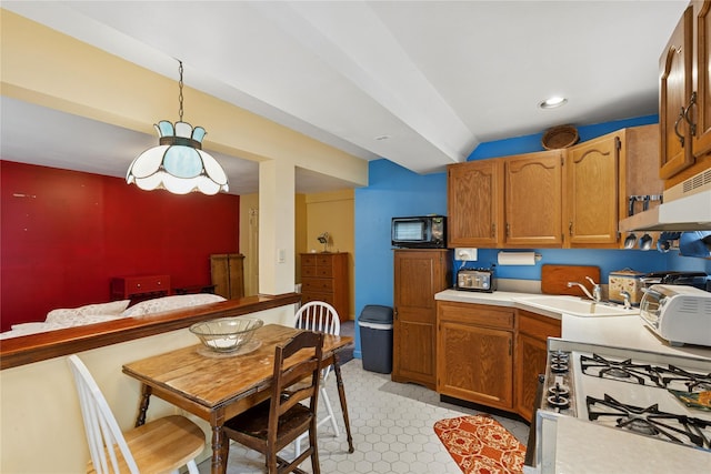 18 Berkeley Ave, Selden, NY 11784 - kitchen with gas range oven, light countertops, brown cabinetry, under cabinet range hood, and recessed lighting