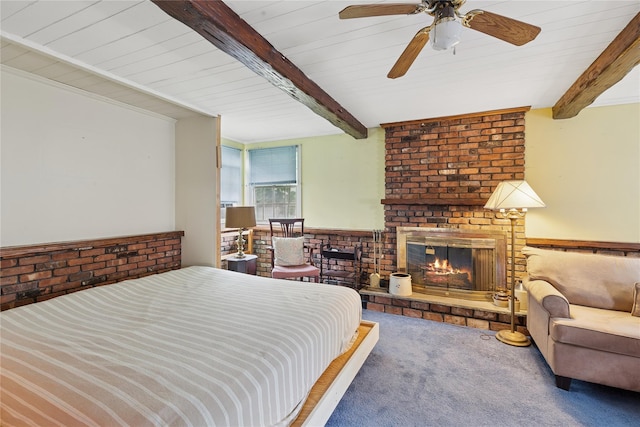 18 Berkeley Ave, Selden, NY 11784 - bedroom featuring carpet floors, wainscoting, a brick fireplace, and a wooden ceiling with exposed beams