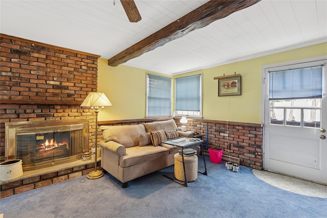 18 Berkeley Ave, Selden, NY 11784 - carpeted living room with a wainscoted wall, a wood ceiling with exposed beams, a brick fireplace, and ceiling fan