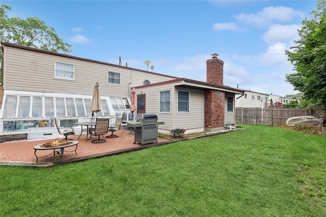 18 Berkeley Ave, Selden, NY 11784 - back of property featuring an outdoor fire pit, a chimney, and a patio area