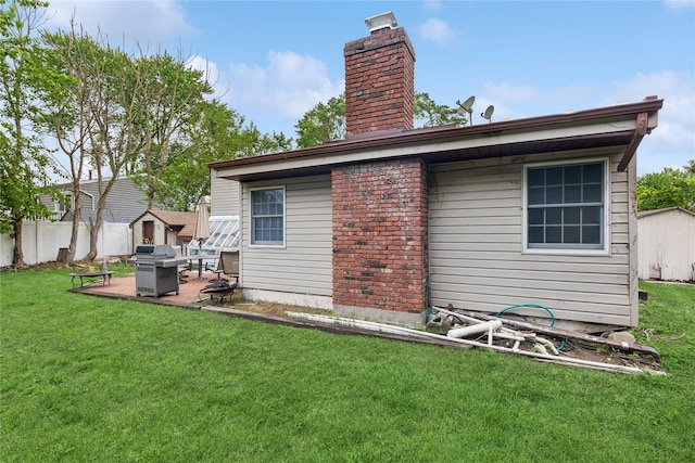 18 Berkeley Ave, Selden, NY 11784 - back of house with a chimney, a fire pit, and a patio