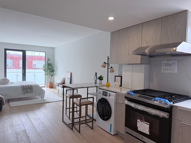 136-80 41st Ave Unit 6H, Flushing, NY 11355 - kitchen with gas range, washer / clothes dryer, ventilation hood, modern cabinets, and light wood-style floors