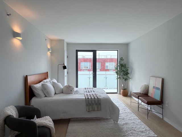 136-80 41st Ave Unit 6H, Flushing, NY 11355 - bedroom with access to outside and light wood-style flooring