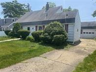 50 Cliff Ln, Levittown, NY 11756 - view of front of property with concrete driveway, a garage, and a front yard