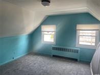 50 Cliff Ln, Levittown, NY 11756 - bonus room featuring radiator and vaulted ceiling