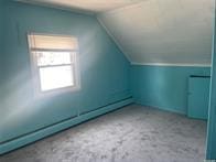 50 Cliff Ln, Levittown, NY 11756 - additional living space with lofted ceiling and a baseboard heating unit